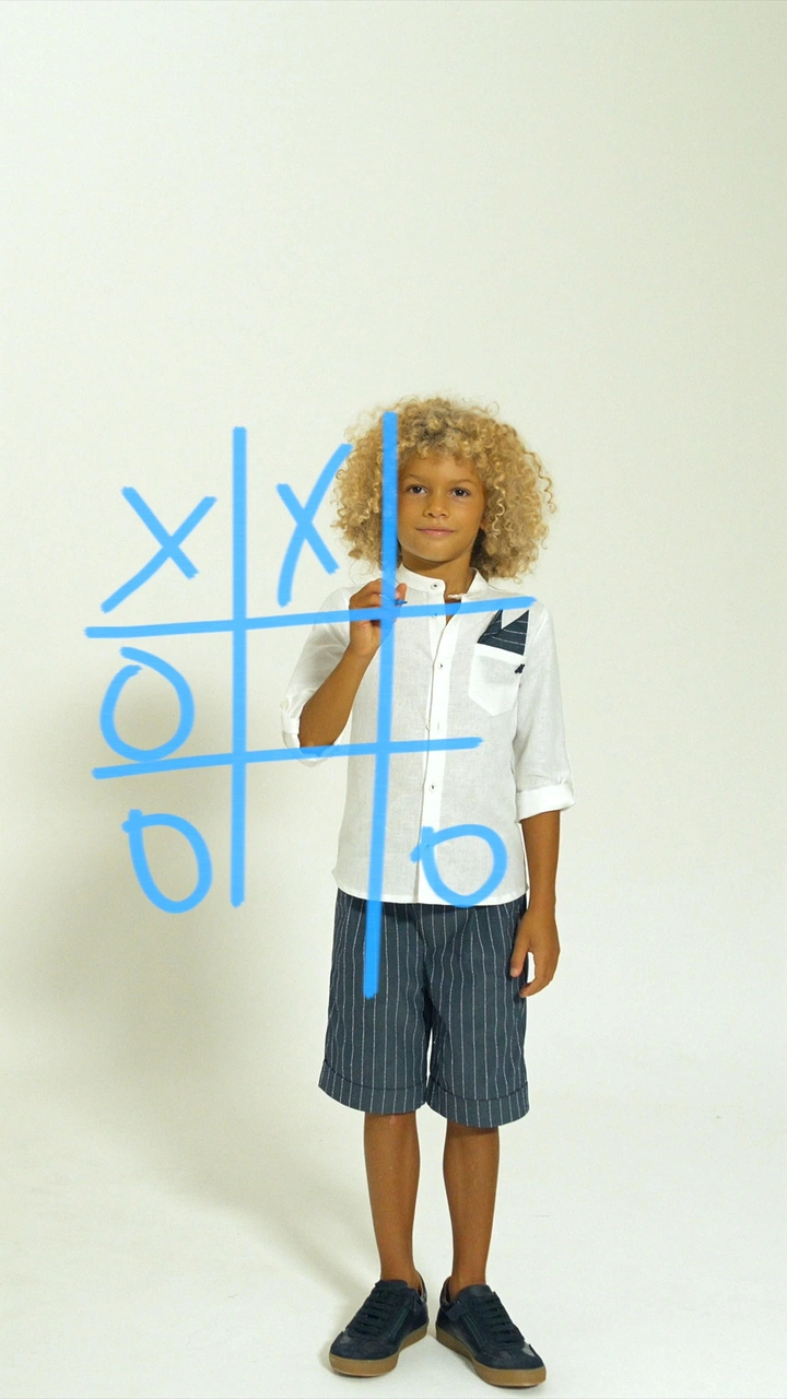 Kids Clothing creative ad: Tic-tac-toe doodle framing kid