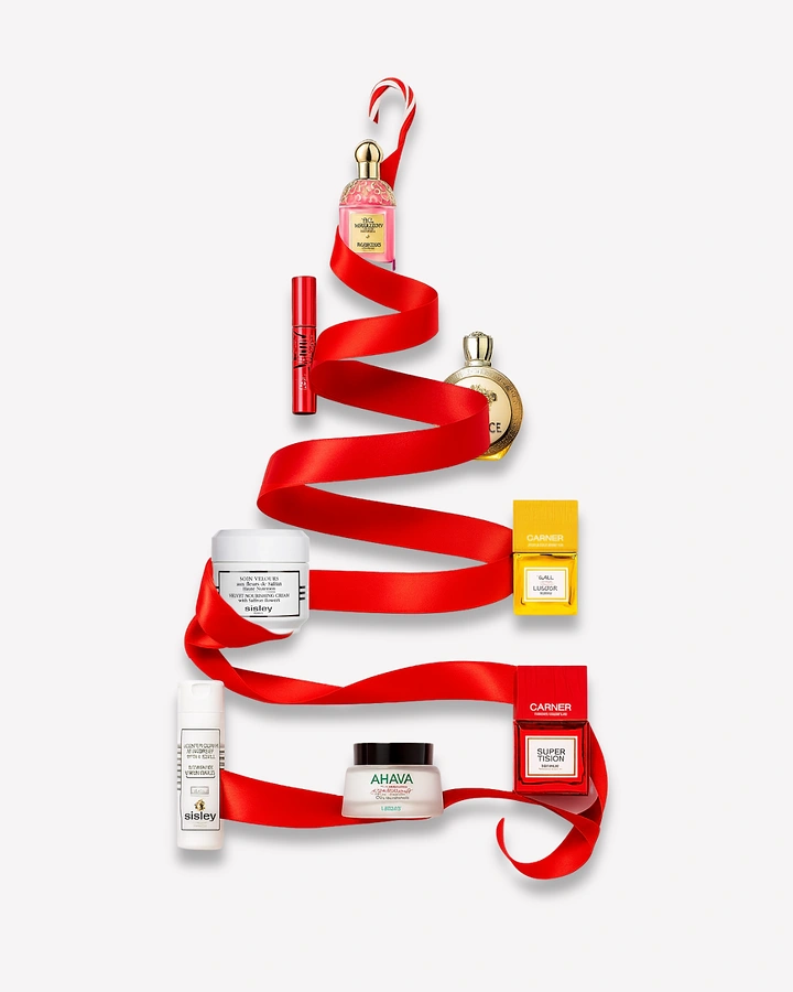 Christmas creative ad: Red satin ribbon zigzagging into a Christmas tree with beauty products placed along it