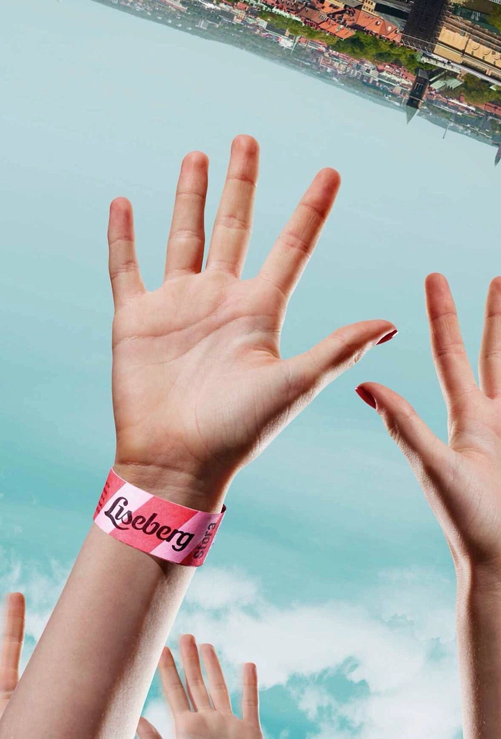 Amusement & Water Parks creative ad: Raised hands with Liseberg wristband, ride feeling