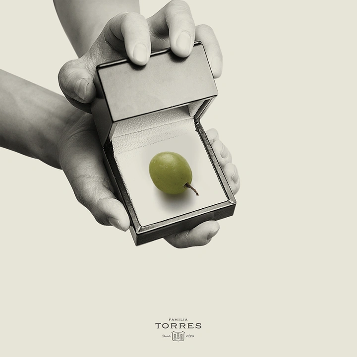 Valentine's Day creative ad: Hands opening a ring box holding a single grape