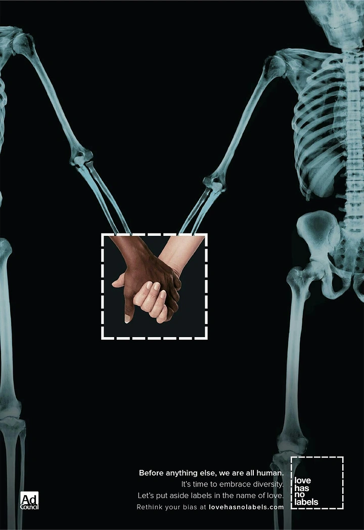 Creative ad: Two X-ray skeletons holding hands, revealed as hands of different skin tones