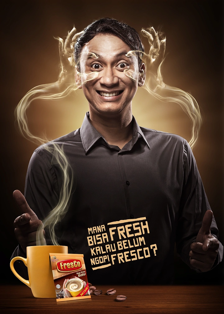 Creative ad: Wide-eyed grinning man whose eyes are pried open by steam hands rising from coffee