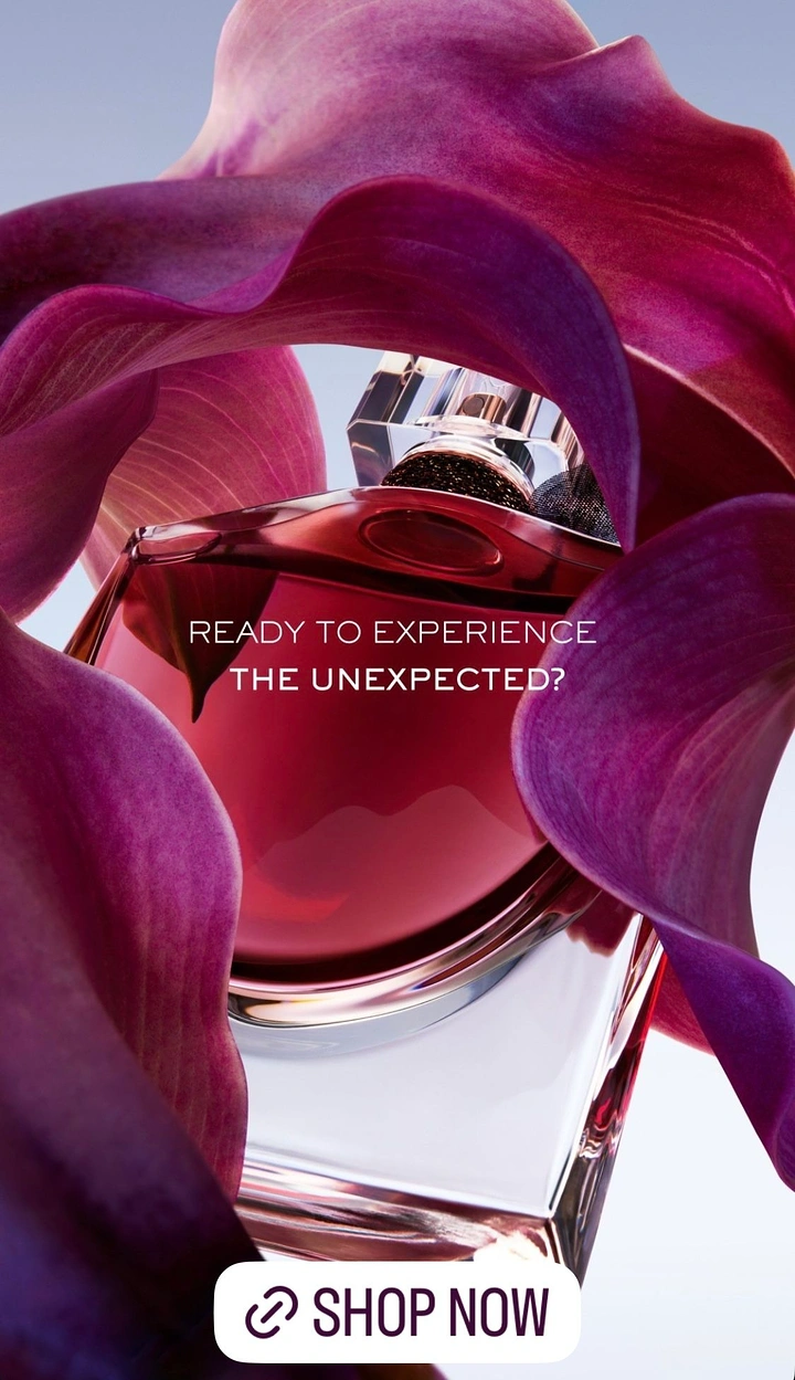 Creative ad: Red perfume bottle framed by swirling magenta calla lily petals