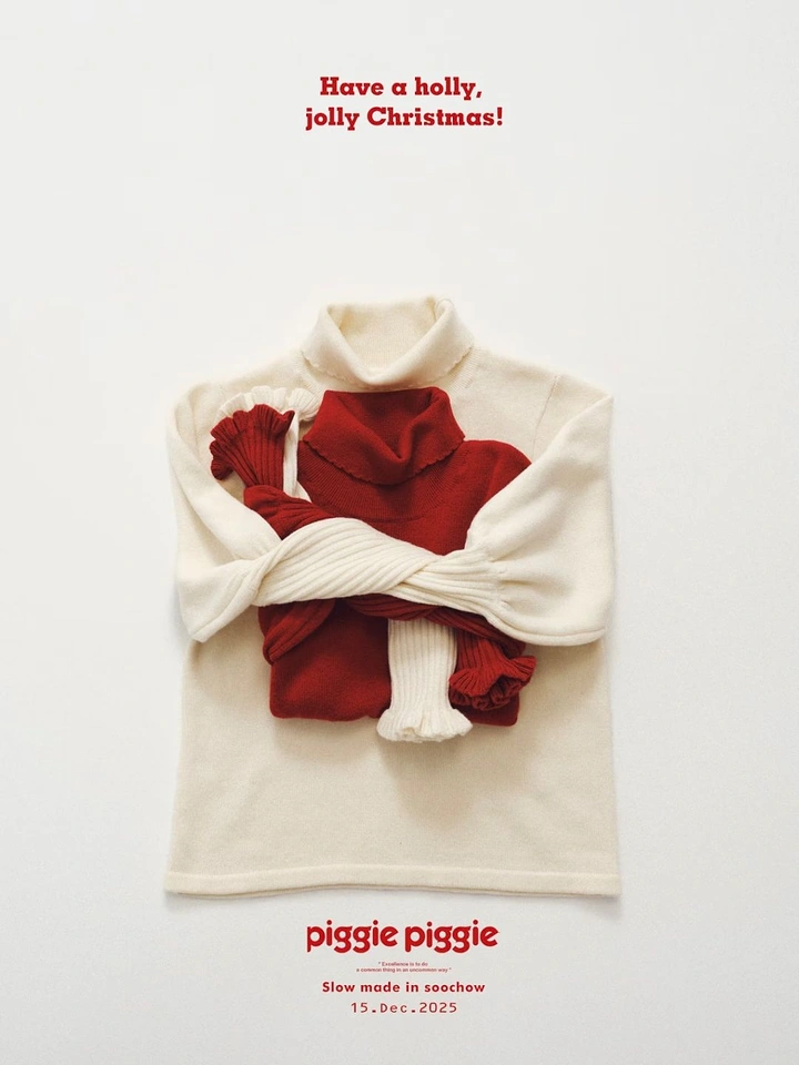 Christmas creative ad: Cream turtleneck sweater hugging a red knit sweater, flat lay