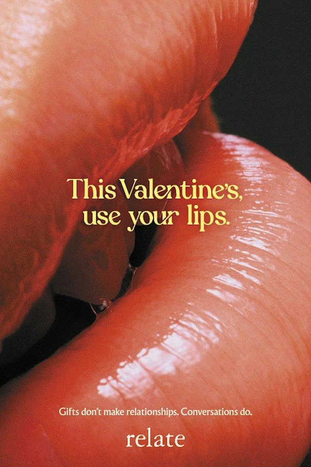 Valentine's Day creative ad: Extreme macro of two glossy red lips about to kiss