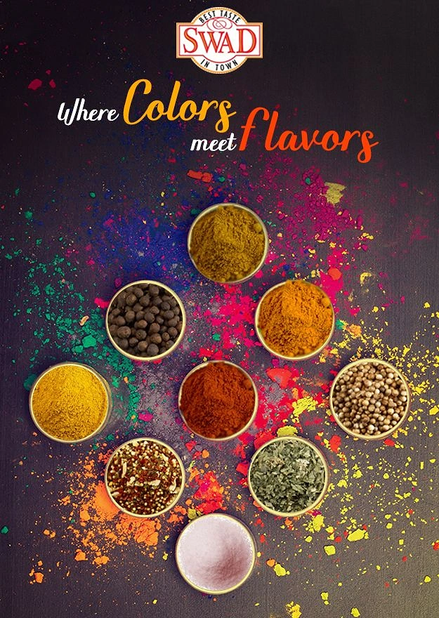 Holi creative ad: Top-down bowls of ground and whole spices on scattered Holi colours