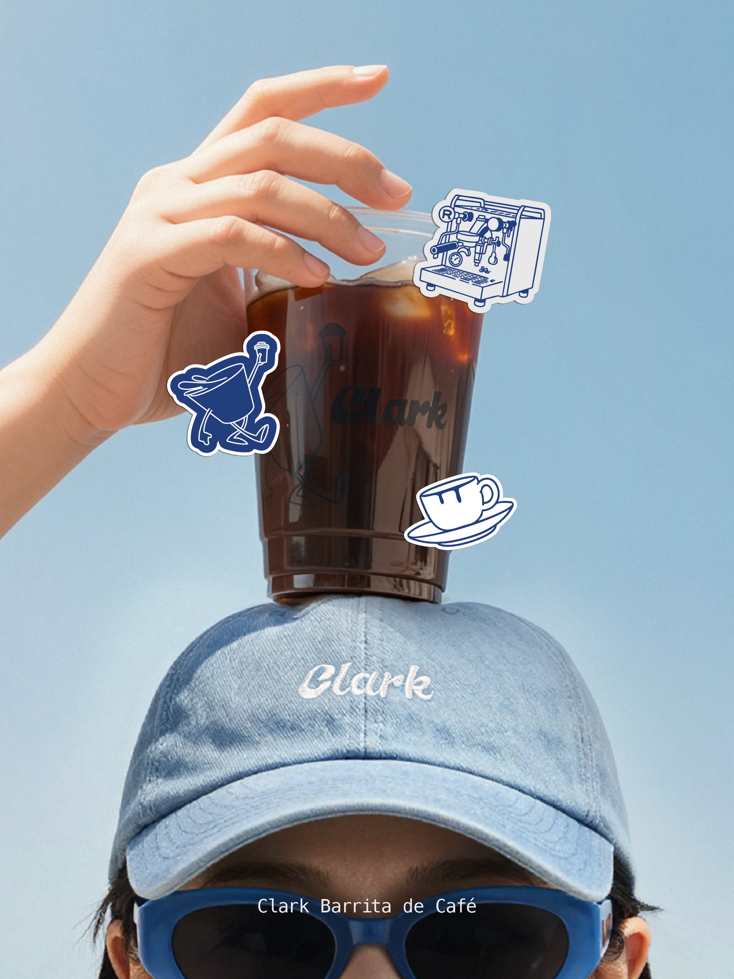 Instagram post: Iced americano balanced on a person's denim cap against the sky