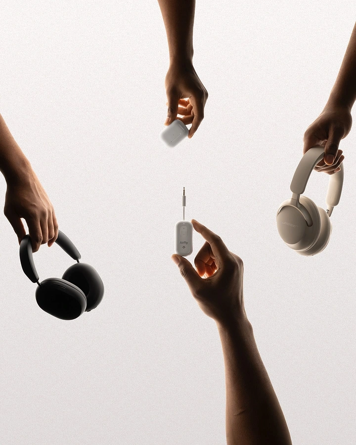 Headphones & Speakers creative ad: Surreal floating hands exchange headphones