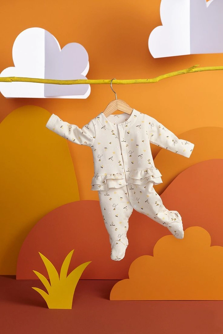 Kids Clothing creative ad: Papercraft landscape, onesie hung on branch