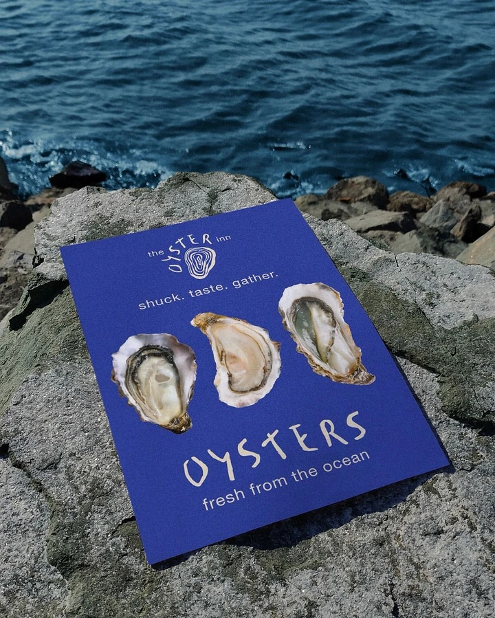Seafood Restaurants creative ad: Oyster menu staged directly on shoreline