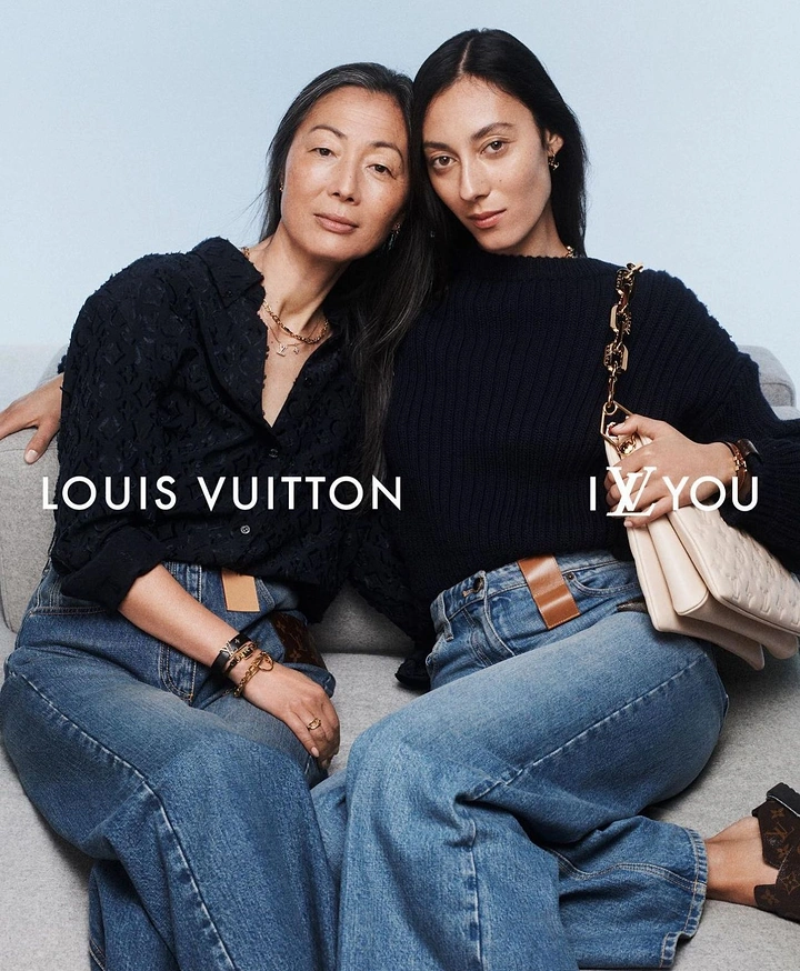 Mother's Day creative ad: Mother and daughter seated close together on a grey sofa
