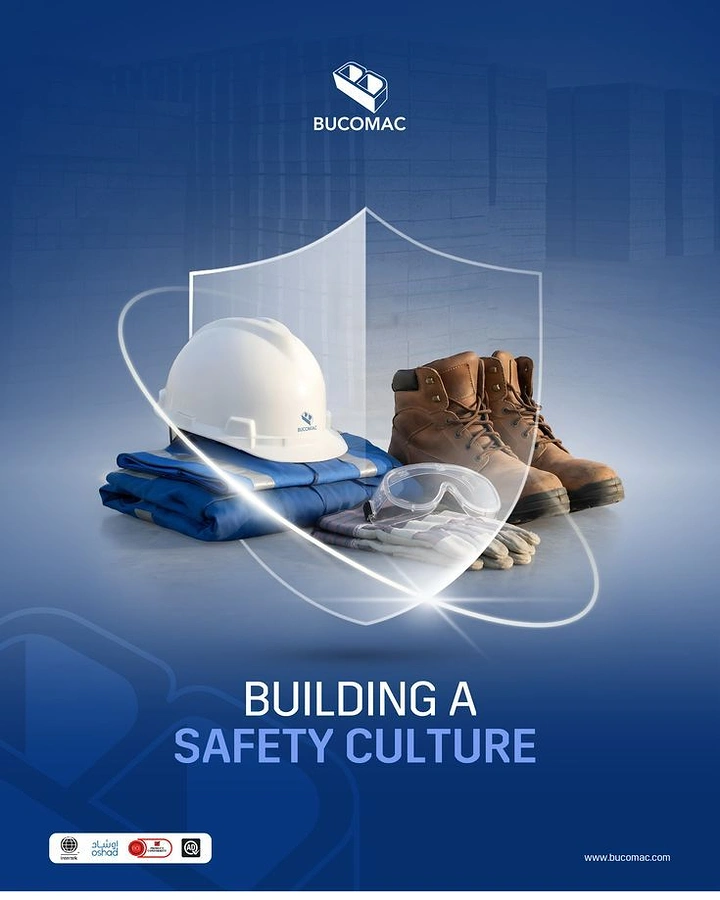 Manufacturing & Industrial Machinery creative ad: PPE kit (hard hat, boots, coveralls, goggles, gloves) behind a glass shield
