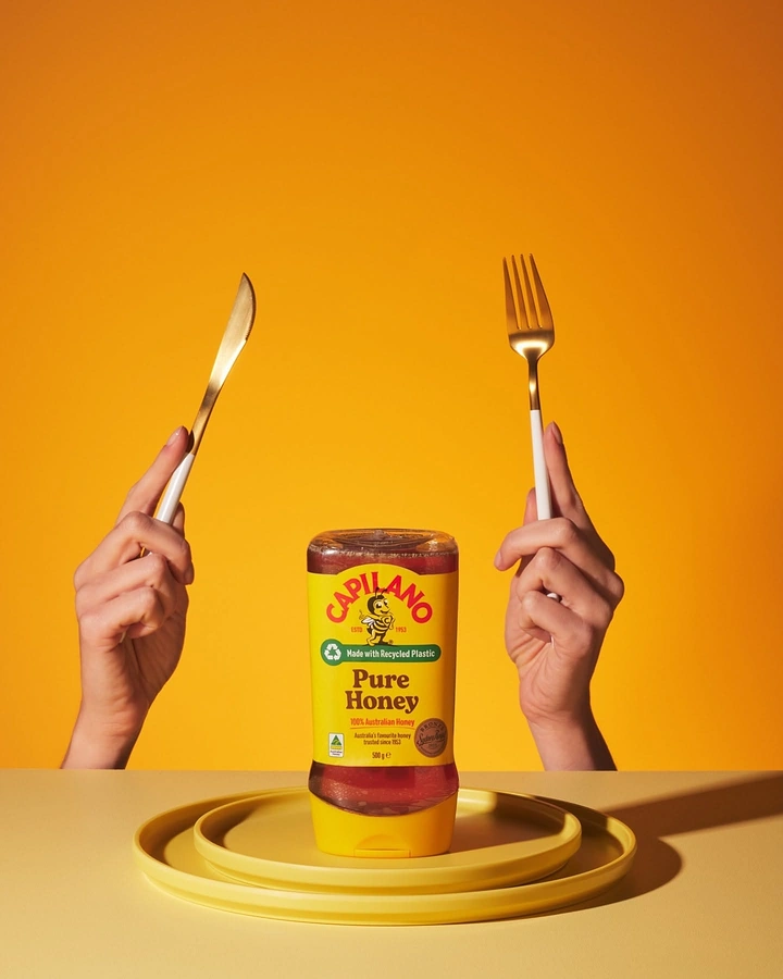 Honey Brands creative ad: Cutlery frames honey as table centerpiece