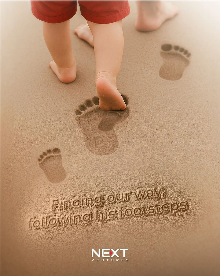 Father's Day creative ad: Toddler's bare feet stepping into an adult's footprints on sand