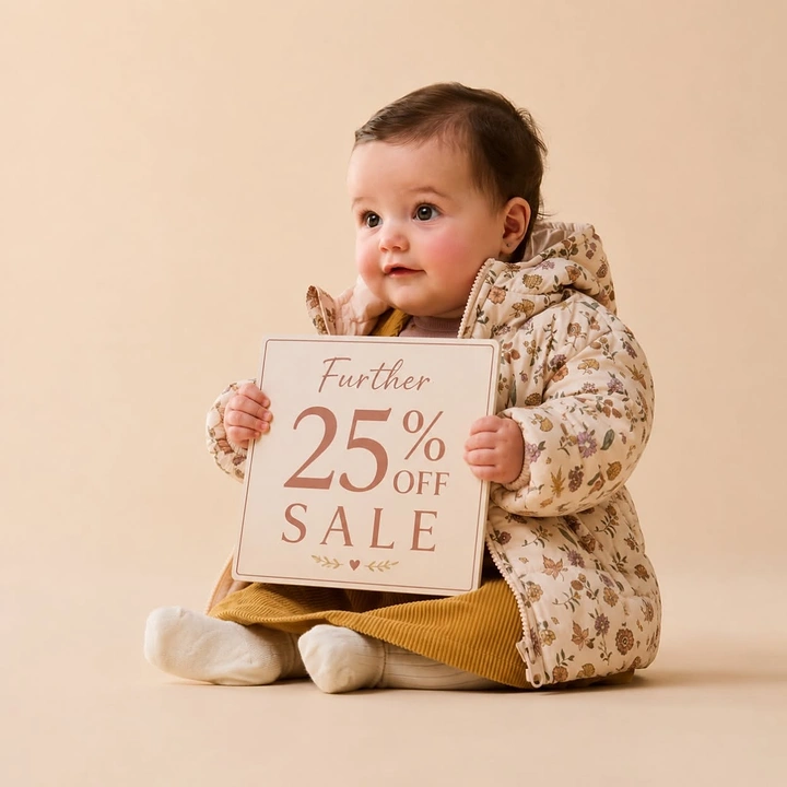 Kids Clothing creative ad: Baby holding sale sign as prop