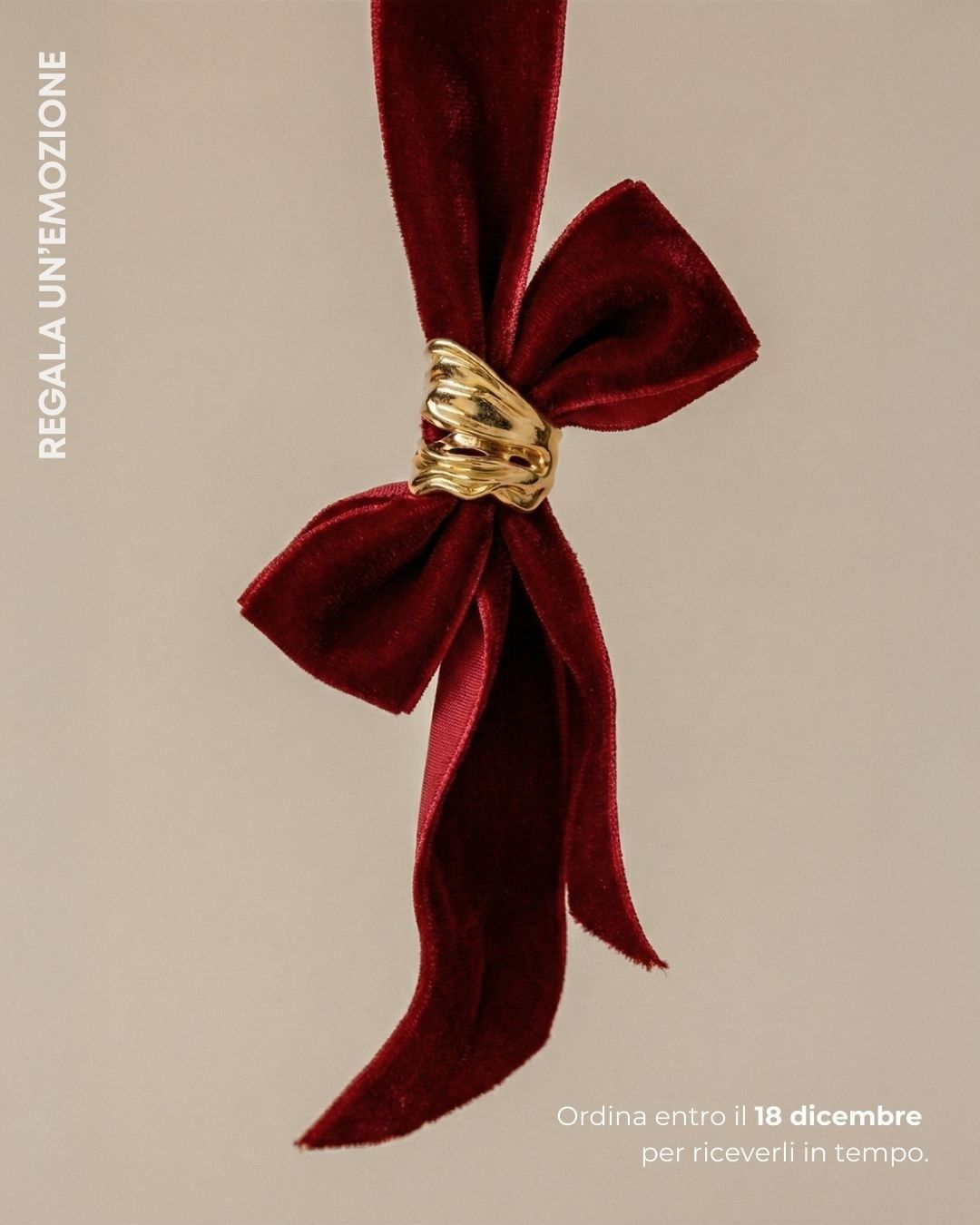 Gold sculptural ring on a red velvet bow