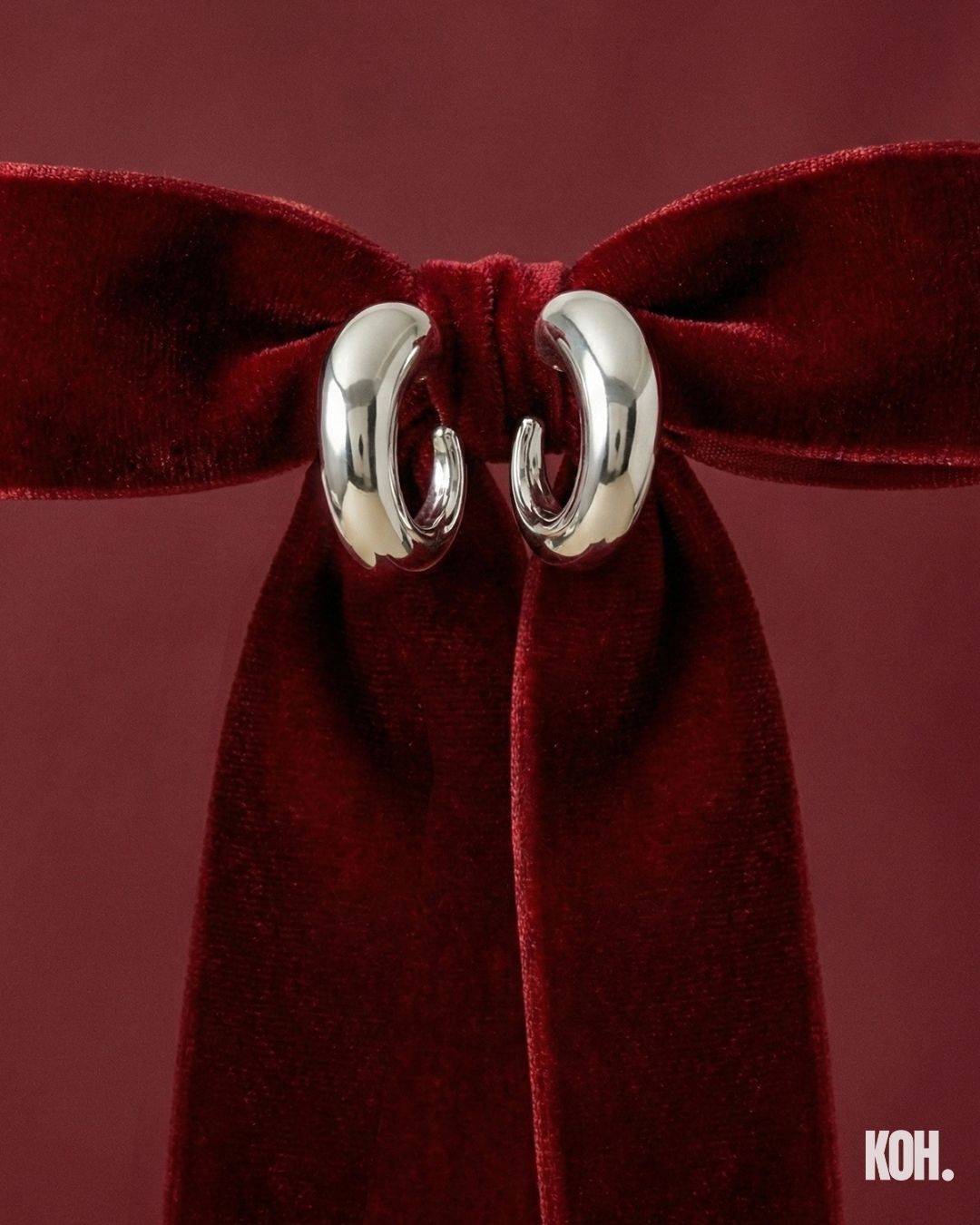 Gold sculptural ring on a red velvet bow