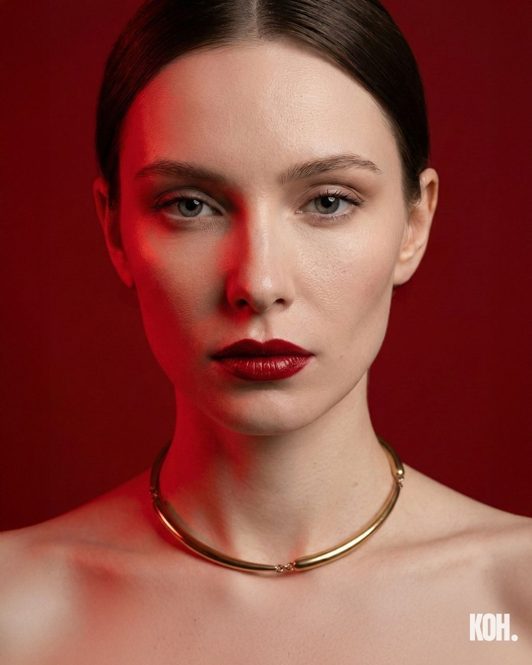 Gold sculptural ring on a red velvet bow