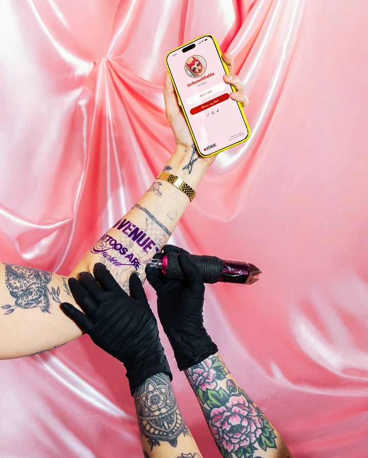 Tattoo Studios creative ad: Tattooing brand name on arm, pink satin