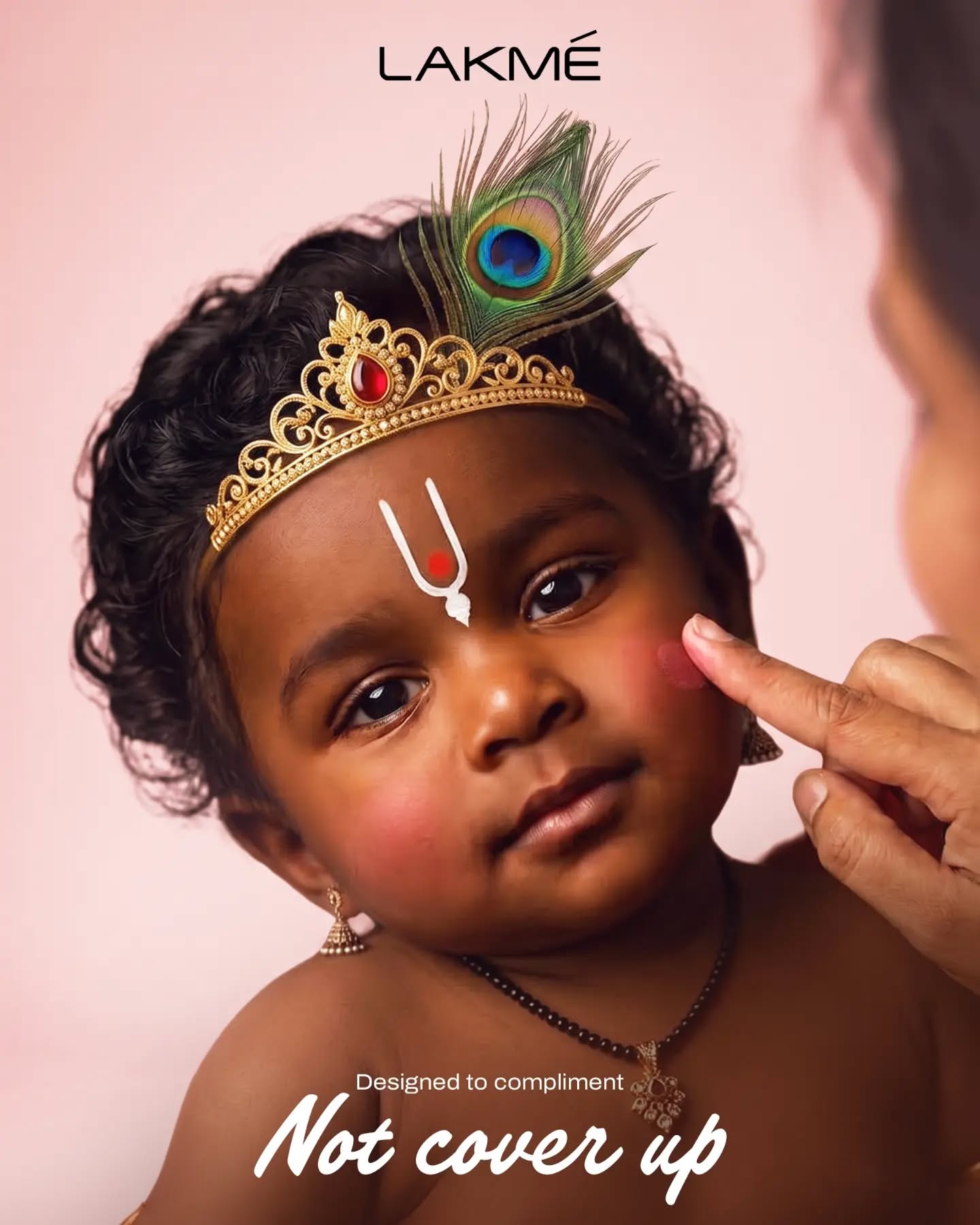 Toddler dressed as Krishna on brick steps reaching for pot