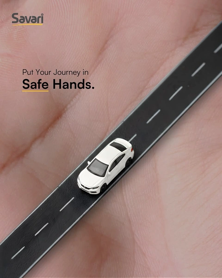 Car Rental creative ad: Toy white sedan driving on a strip of road laid across an open palm
