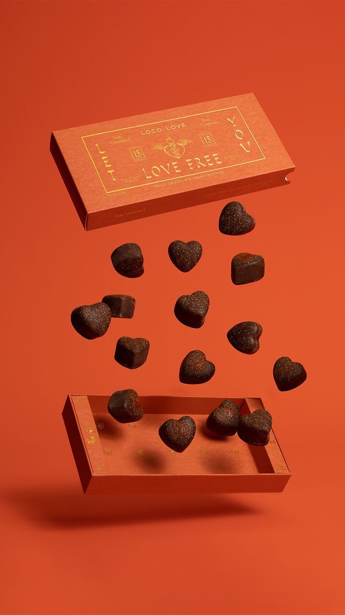 Valentine's Day Story: Heart truffles floating between an open gift box lid and tray