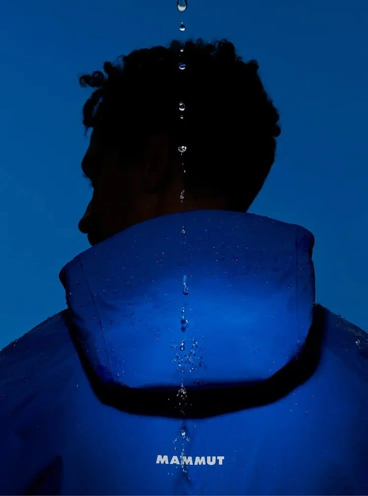Waterproofing creative ad: Dramatic rainwear campaign portrait
