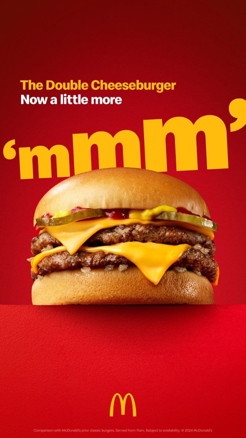 Story: Double cheeseburger with melting cheese on a red ledge