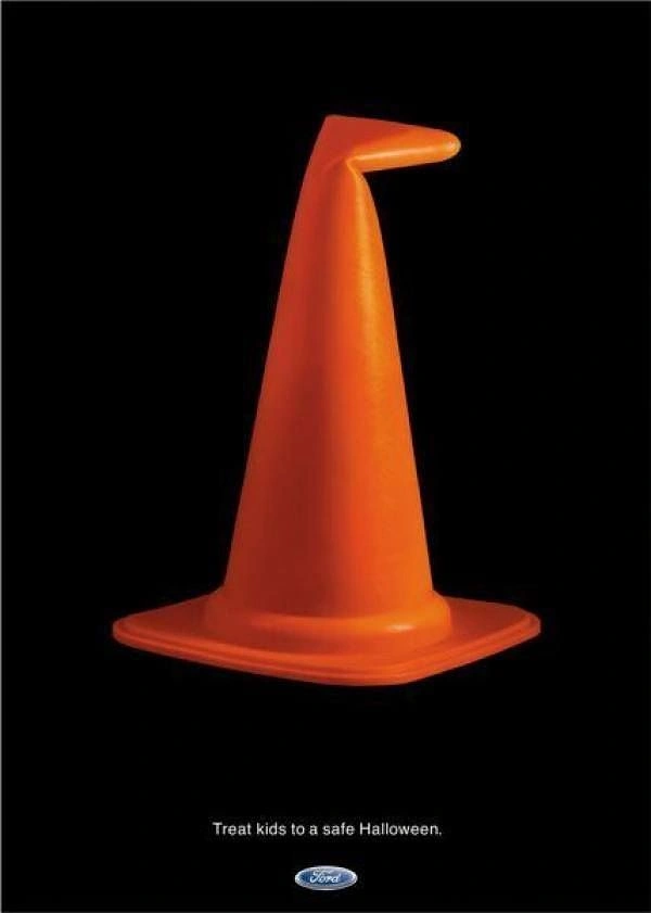 Halloween creative ad: Orange traffic cone bent into a witch hat