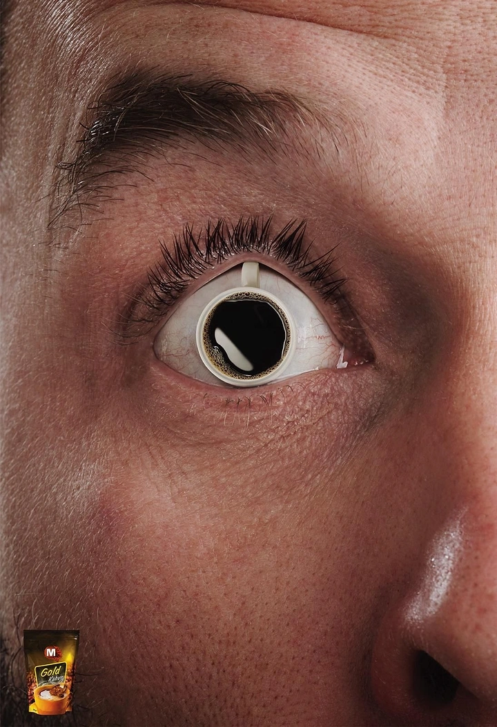 Soft Drinks & Beverages creative ad: Extreme close-up of a wide-open eye whose iris is a cup of black coffee