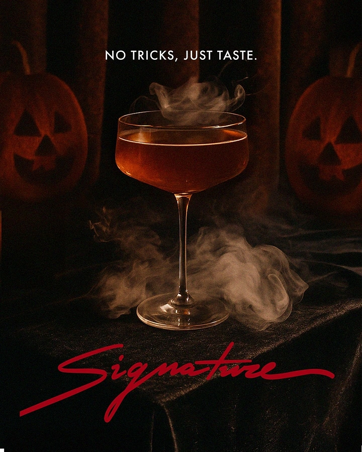 Halloween creative ad: Smoking amber cocktail in a coupe glass
