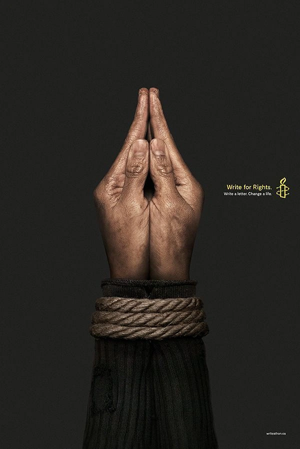 Creative ad: Rope-bound hands pressed together into a pen-nib shape