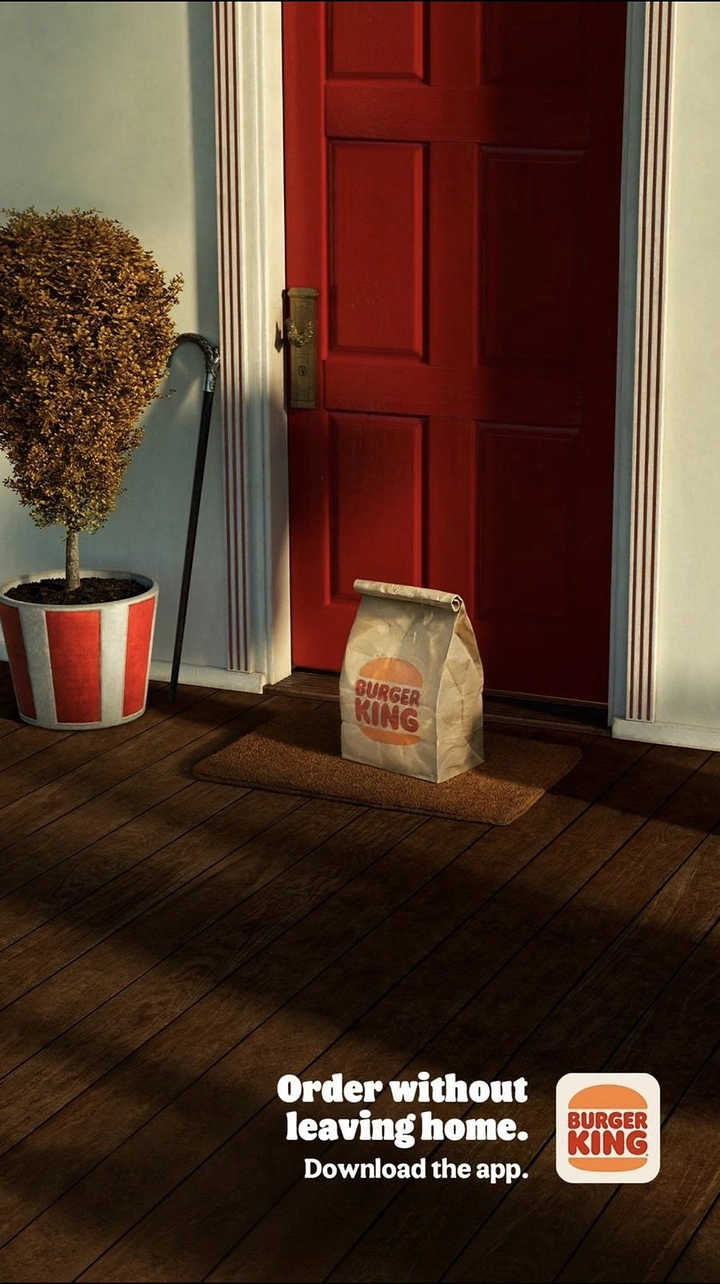 Fast Food creative ad: Takeaway bag waiting on a doormat in front of a red door