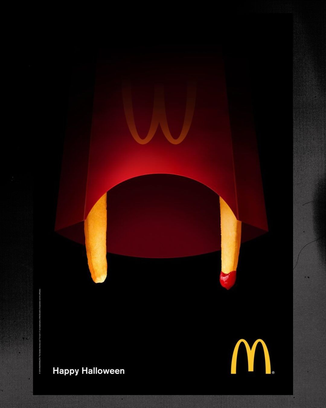 Fries carton seen from below, with two fries as vampire fangs