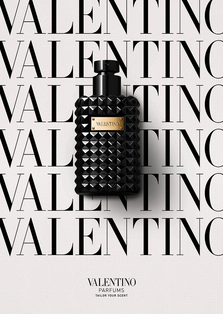 Creative ad: Black studded perfume bottle on repeated wordmark