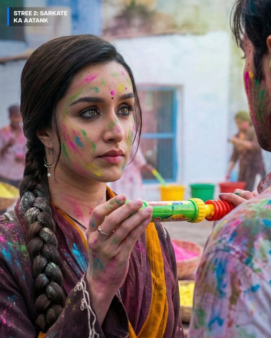Holi Instagram post: Ornate brass pichkari with a pink condom-like water balloon at its tip, slide 2