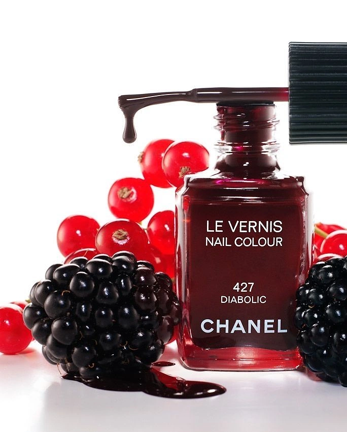 Nail Polish Brands creative ad: Chanel polish framed as berry still life