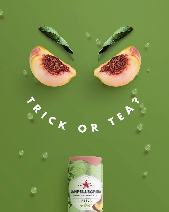 Halloween creative ad: Angry face made of peach halves and leaves, with a drink can as the chin