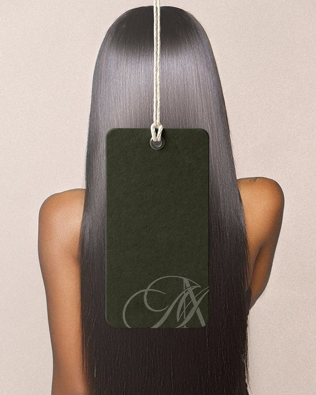 Instagram post: Back view of a woman with sleek long straight hair, with a dark green hang tag over it