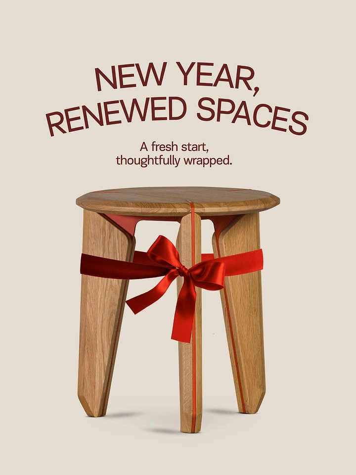 New Year creative ad: Oak three-legged stool tied with red ribbon bow