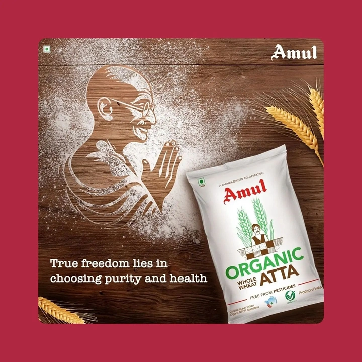 Gandhi Jayanti creative ad: Organic flour package beside a flour-dusted Gandhi profile carved into wood