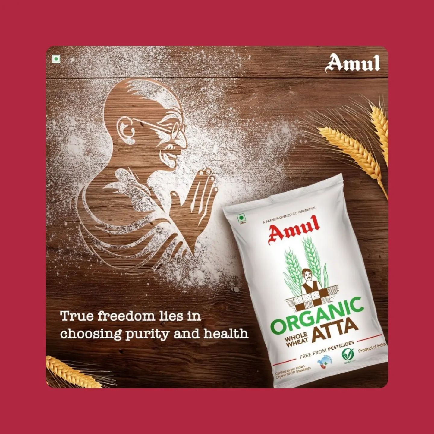 Gandhi Jayanti Poster: Organic flour package beside a flour-dusted Gandhi profile carved into wood