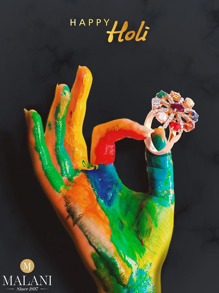 Holi creative ad: Holi-paint-covered hand in a mudra gesture holding a multi-gem ring