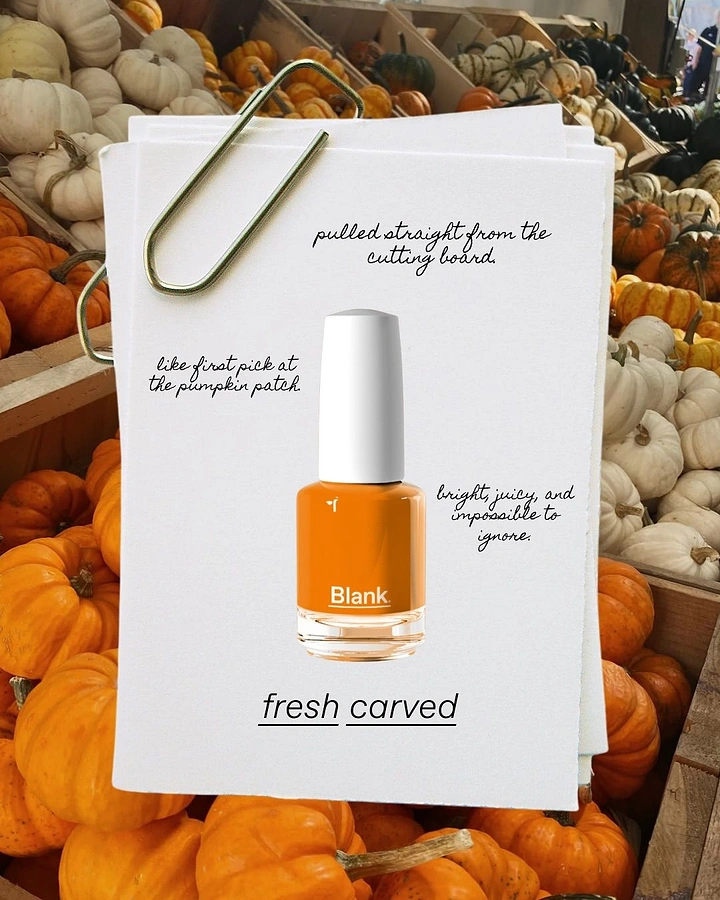 Halloween creative ad: Orange nail polish bottle on clipped paper cards over a pumpkin patch