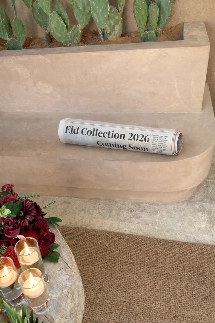 Eid creative ad: Rolled newspaper announcing a collection, lying on a plaster bench