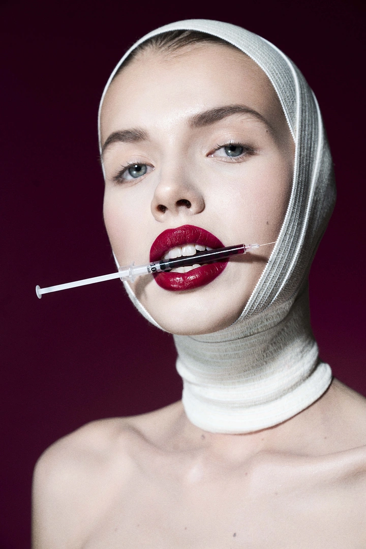 Plastic Surgery Clinics creative ad: Unexpected syringe-through-lips editorial composition