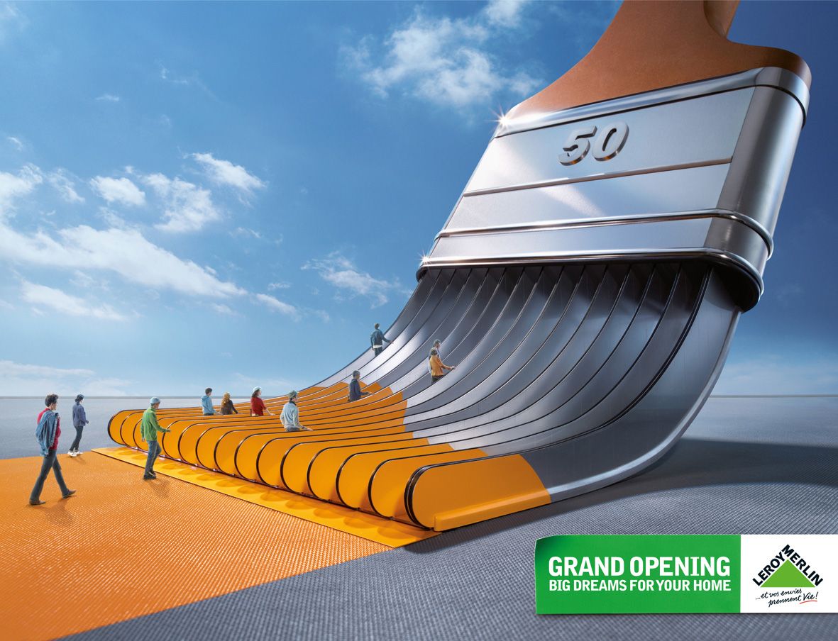 Creative: People walking toward a giant sculptural paintbrush structure