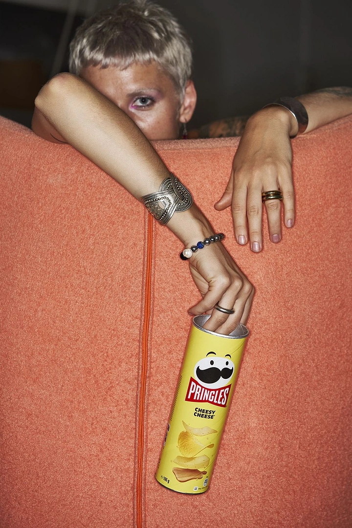 Snacks & Namkeen Brands creative ad: Sneaky hand grabbing can behind couch