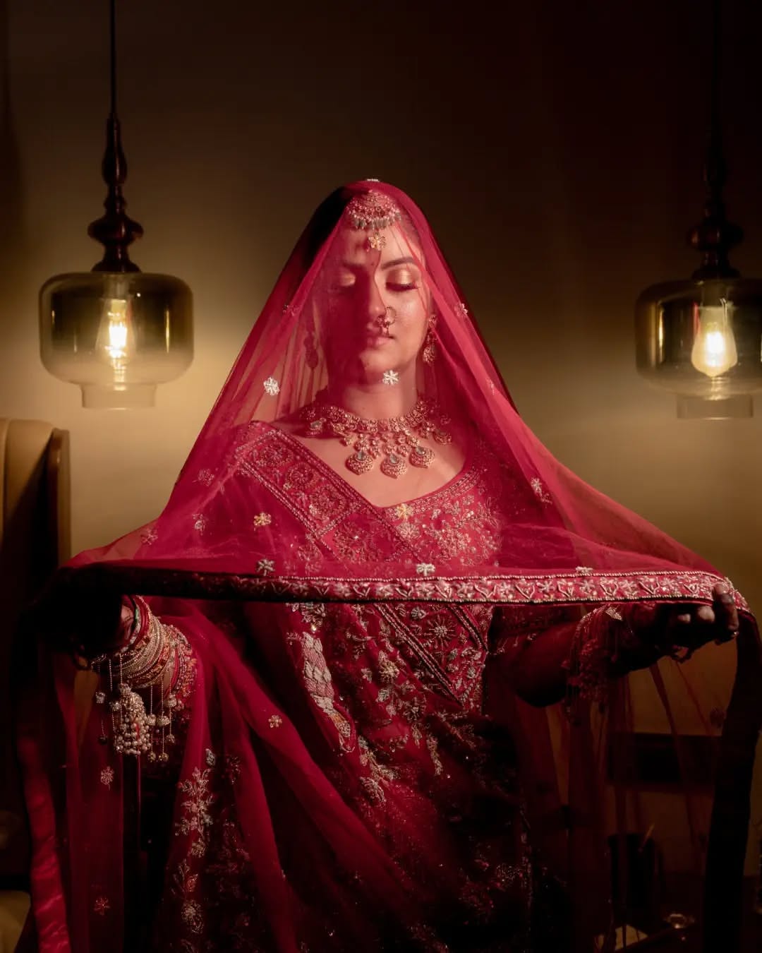Carousel: Indian bride in crimson veil and ornate traditional jewelry, slide 3