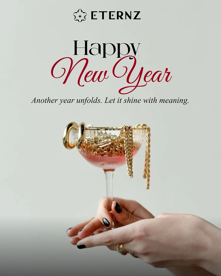 New Year creative ad: Hand holding a champagne coupe filled with gold jewellery